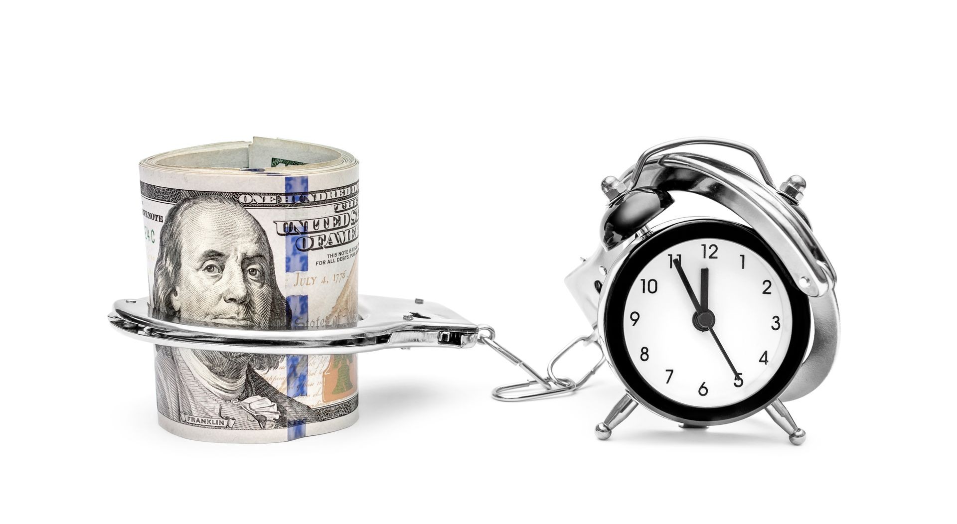 Clock connected by handcuffs with money on white.