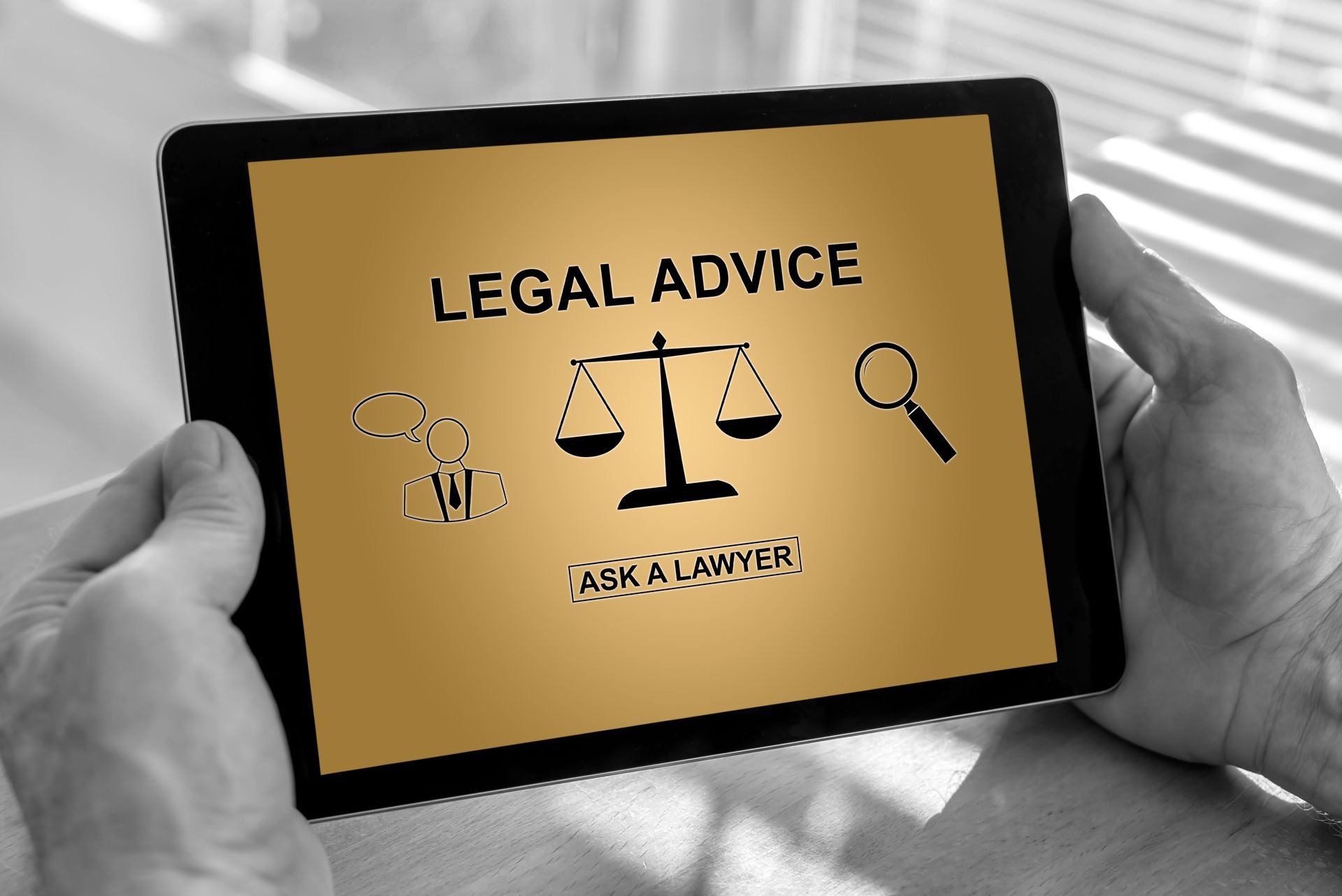 Male hands holding a tablet with legal advice concept