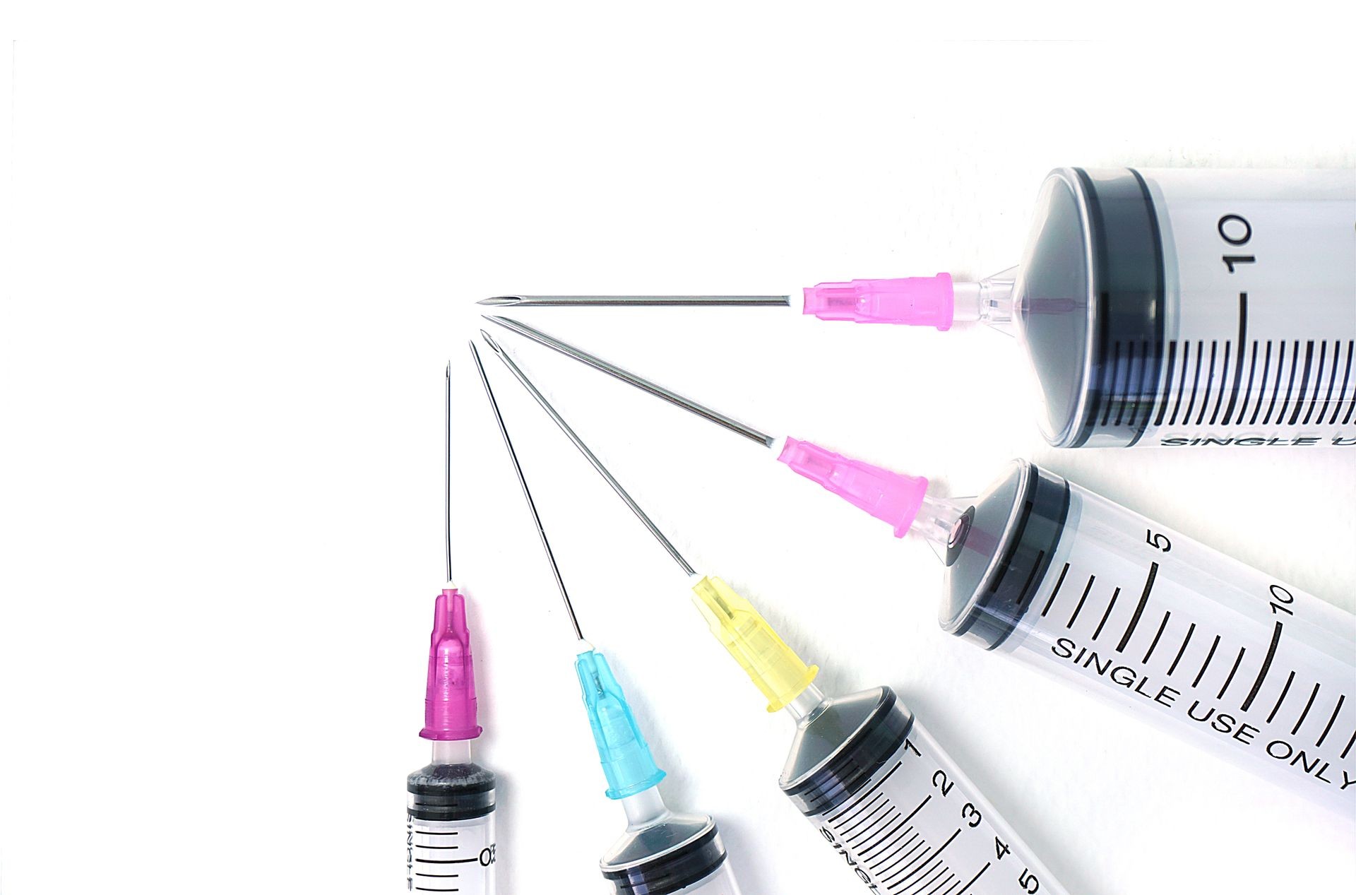 Drug syringes. Empty plastic syringes on white background.                              